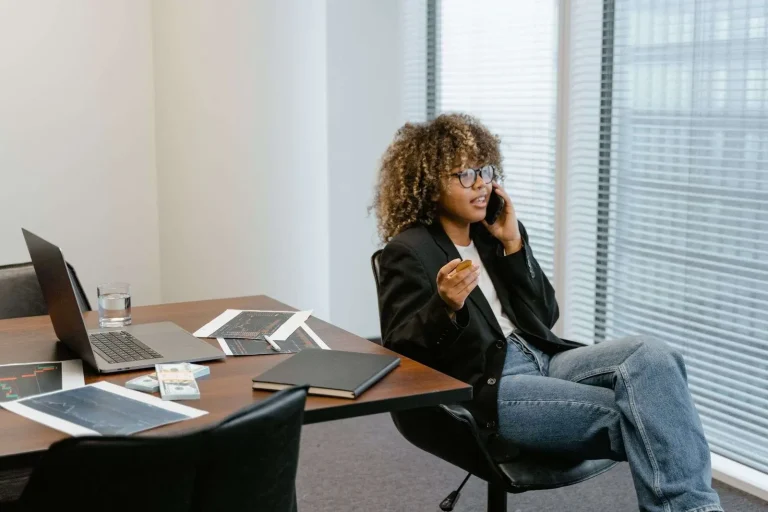 Business professional analyzing cloud phone system pricing and plan comparisons on a laptop