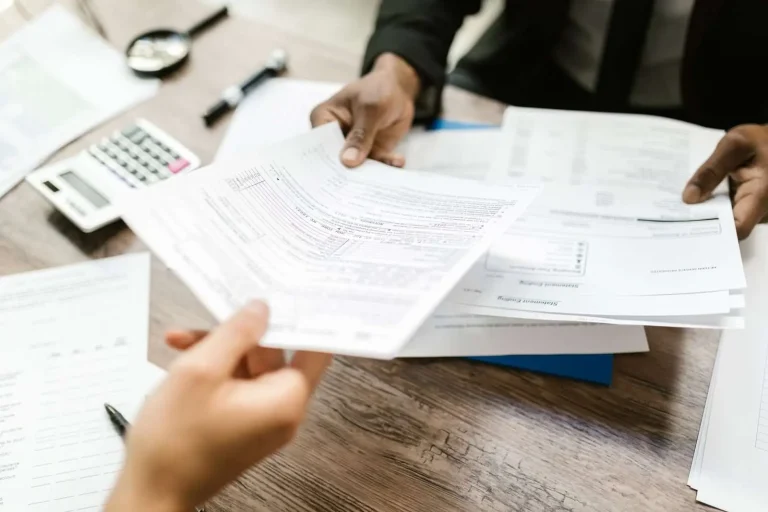 Business owner reviewing insurance policy documents at a desk