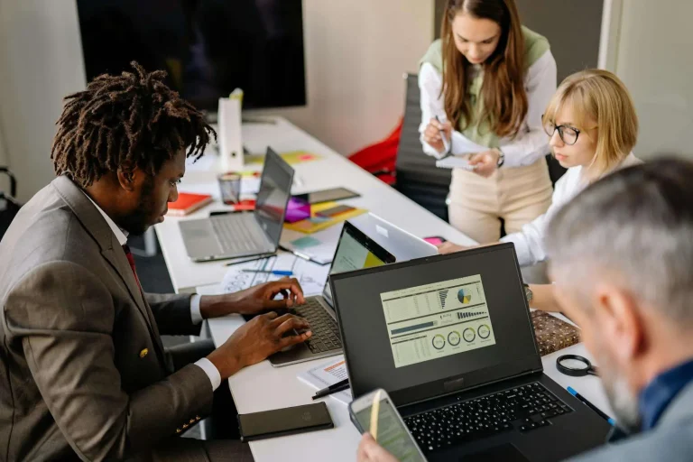 Employees collaborating using digital workplace technology to improve employee experience