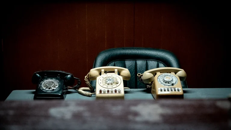 Desk phone on an office workstation configured so that employees can dial 911 directly and send an accurate dispatchable location