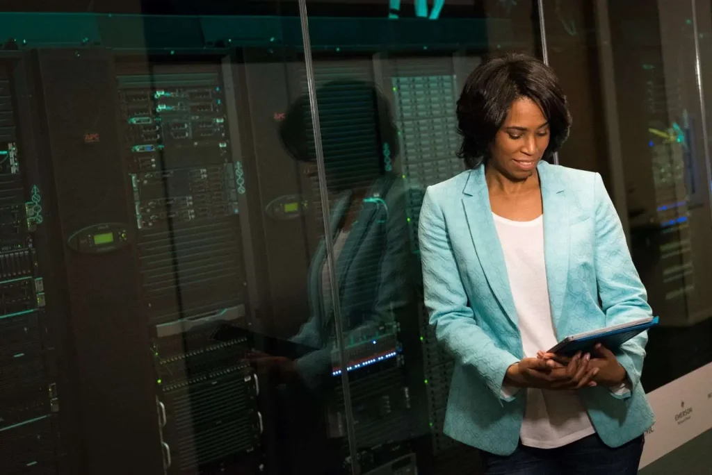 IT professional reviewing enterprise servers in a data center while supporting an internal IT team