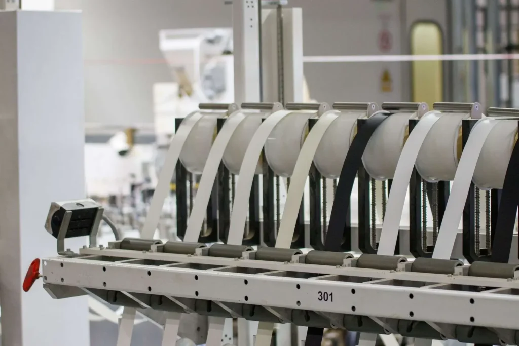 Advanced industrial machinery operating on a manufacturing facility floor, representing modern IT infrastructure supporting production operations