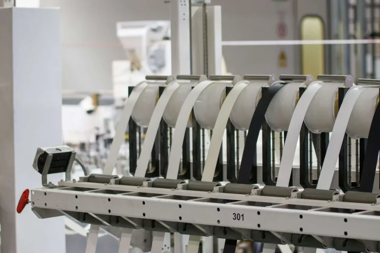 Advanced industrial machinery operating on a manufacturing facility floor, representing modern IT infrastructure supporting production operations