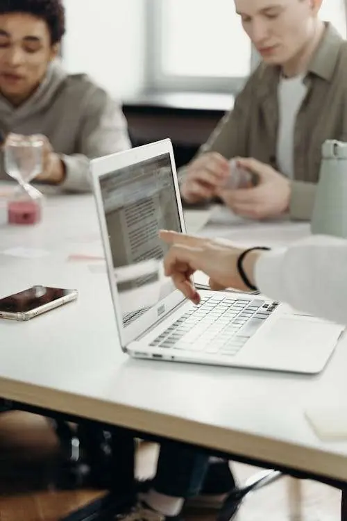 Business professional using laptop with AI-powered productivity tools in modern office