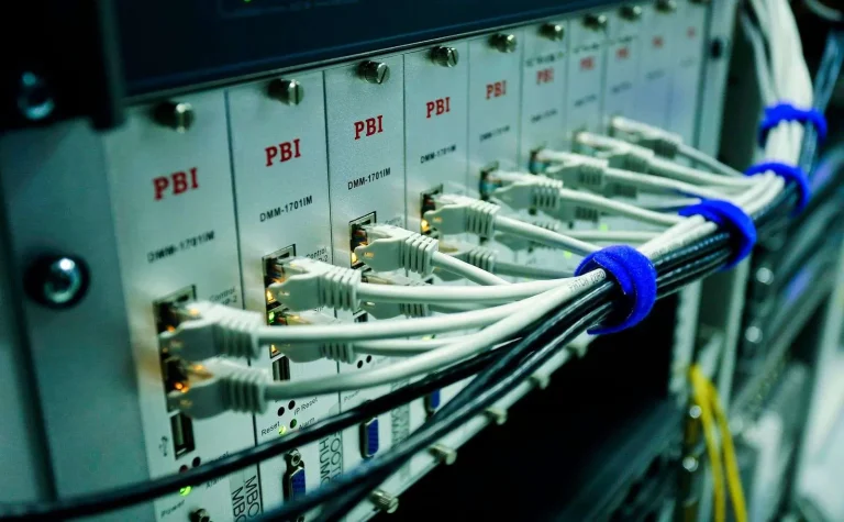 Ethernet cables connected to a network switch panel supporting business internet and VoIP failover