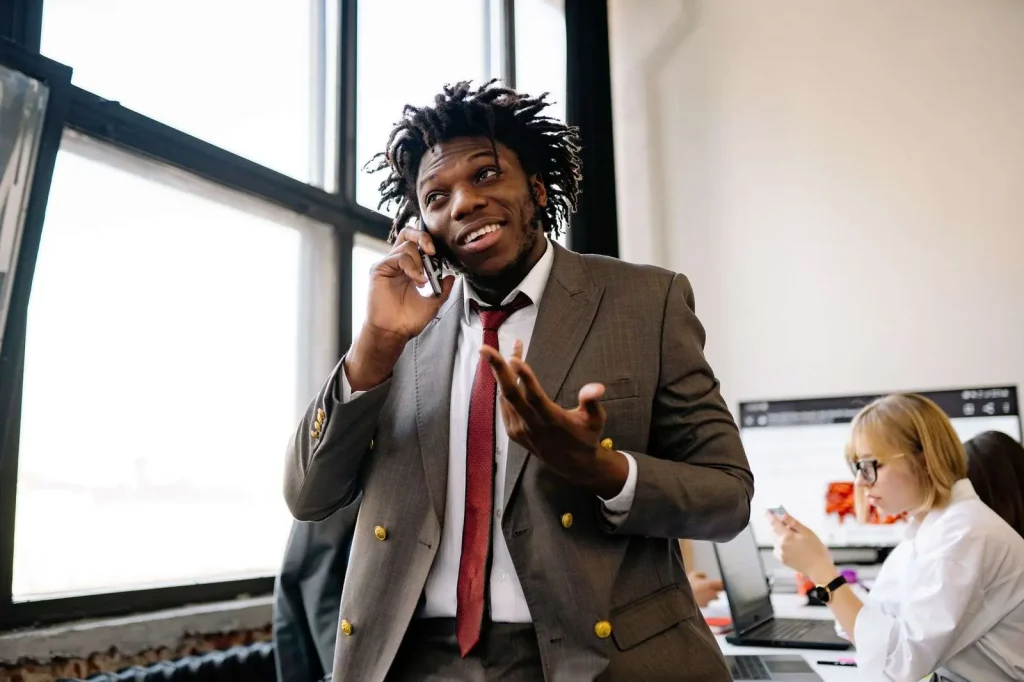 Business professional conducting B2B telemarketing call at desk