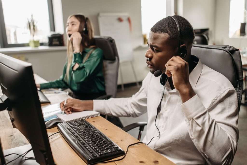 Business team answering customer calls on a SIP trunk-powered phone system