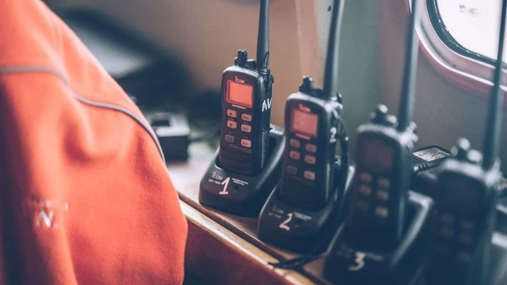 Fleet of professional digital two-way radios resting in charging stations, representing Cytranet's encrypted radio rental inventory for events in Las Vegas and Los Angeles