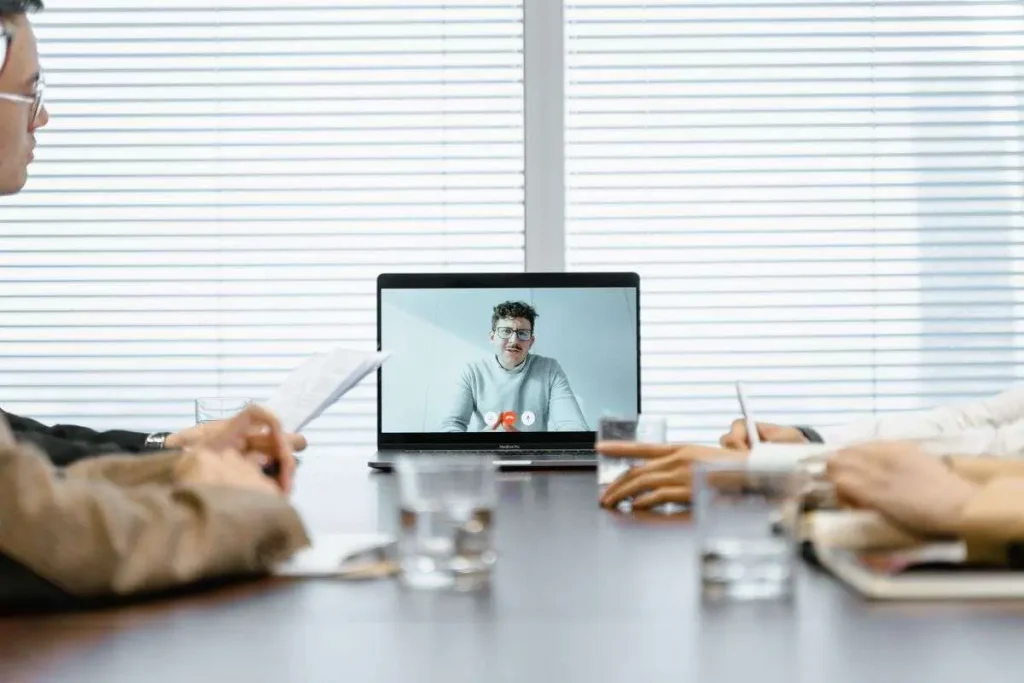 Diverse team of professionals participating in a virtual video meeting in a conference room