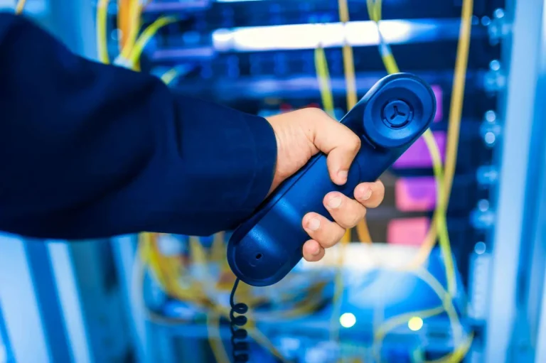 Business telephone handset in a server room representing VoIP security for small and midsized businesses